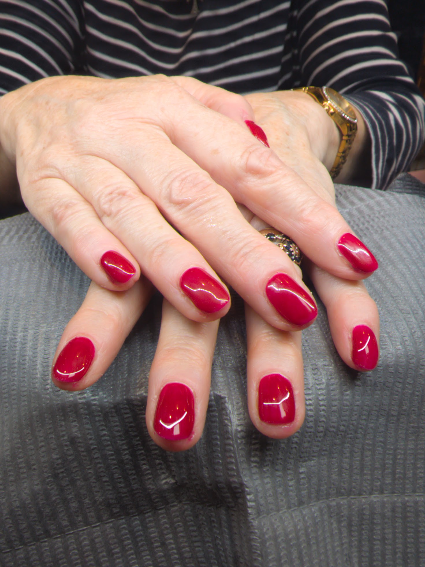 Glossy deep red gel on short rounded nails